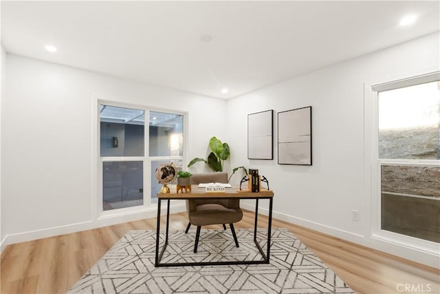 home office with light hardwood / wood-style floors