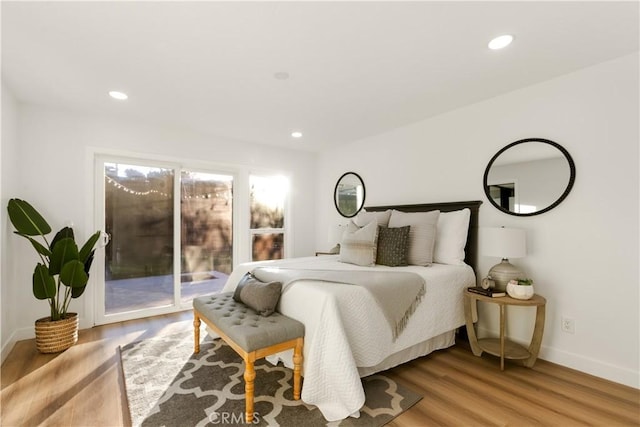 bedroom with access to exterior and light hardwood / wood-style floors