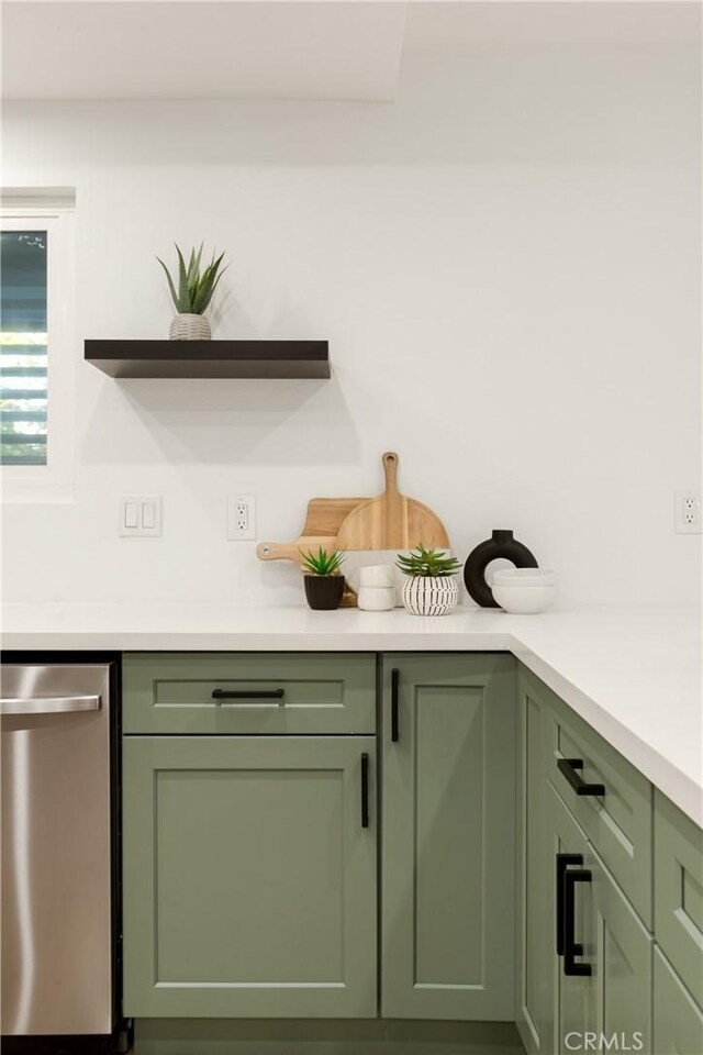 interior space with stainless steel dishwasher and green cabinets