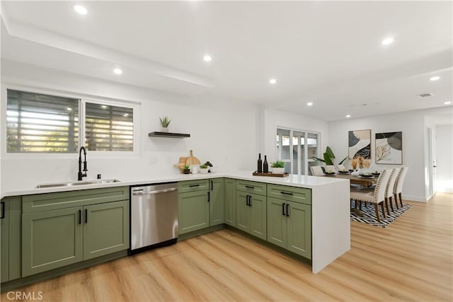 kitchen featuring sink, green cabinetry, stainless steel dishwasher, light wood-type flooring, and plenty of natural light