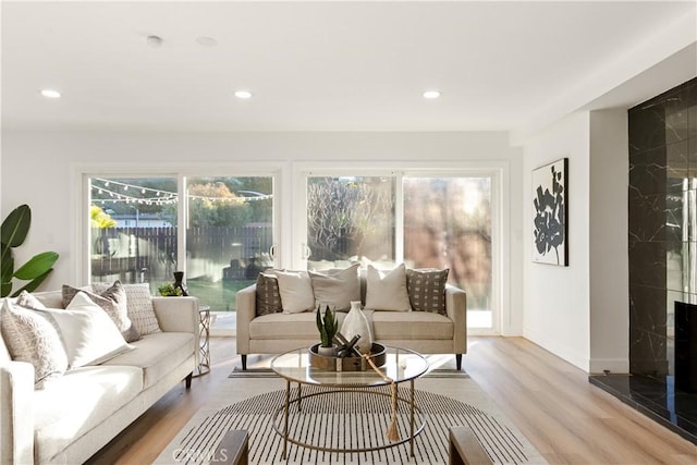 sunroom with plenty of natural light and a high end fireplace