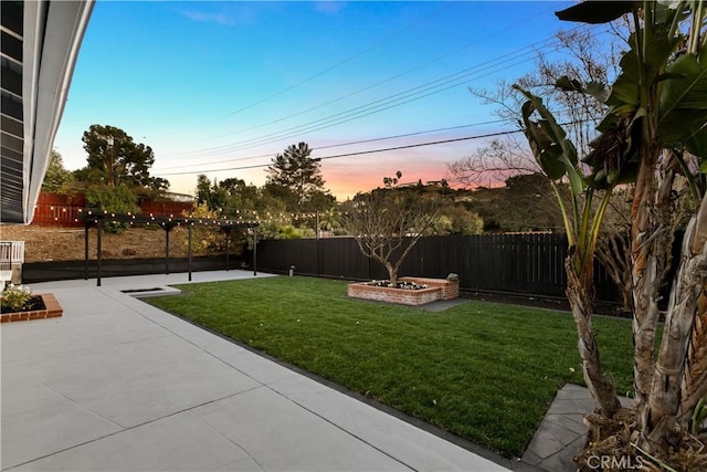 yard at dusk with a pergola and a patio