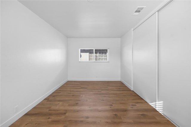 spare room with hardwood / wood-style floors