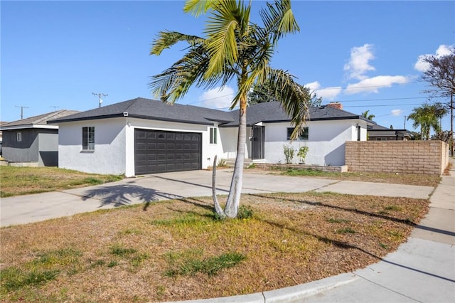 ranch-style home with a garage and a front lawn