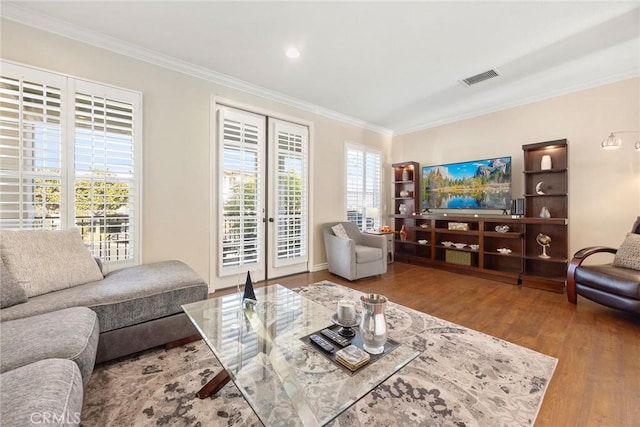 living room featuring a wealth of natural light, crown molding, french doors, and hardwood / wood-style flooring