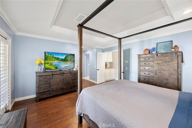 bedroom featuring dark hardwood / wood-style floors, a raised ceiling, and ornamental molding