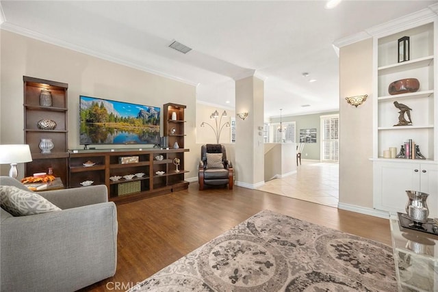 living room featuring crown molding and light hardwood / wood-style flooring