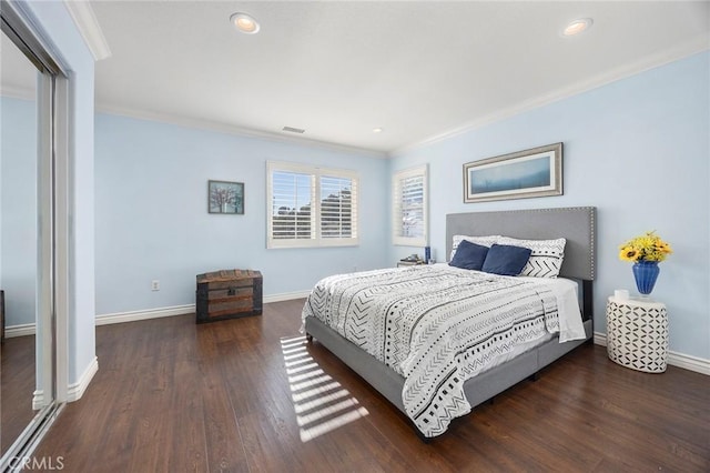 bedroom with dark hardwood / wood-style floors and ornamental molding