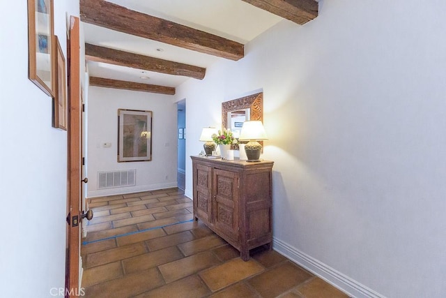 hallway featuring beamed ceiling