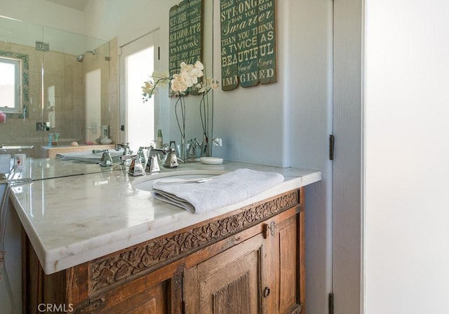 bathroom with vanity and tiled shower