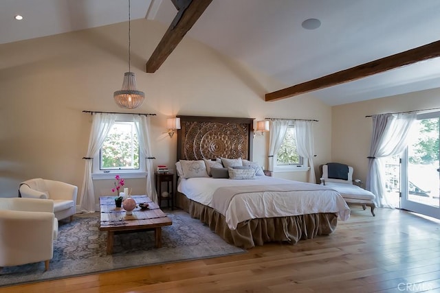 bedroom featuring access to outside, multiple windows, and hardwood / wood-style floors