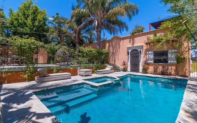 view of swimming pool featuring an in ground hot tub