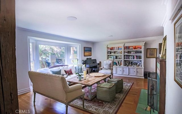 living room featuring ornamental molding and wood-type flooring