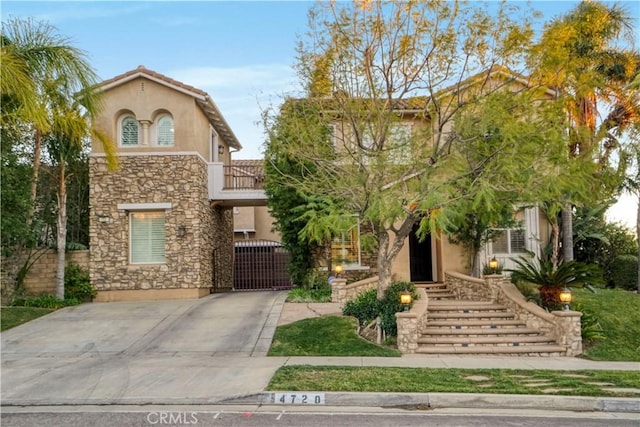 view of front of house featuring stucco siding and stone siding