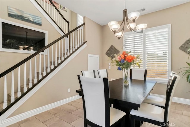 dining area with a notable chandelier and light tile patterned flooring