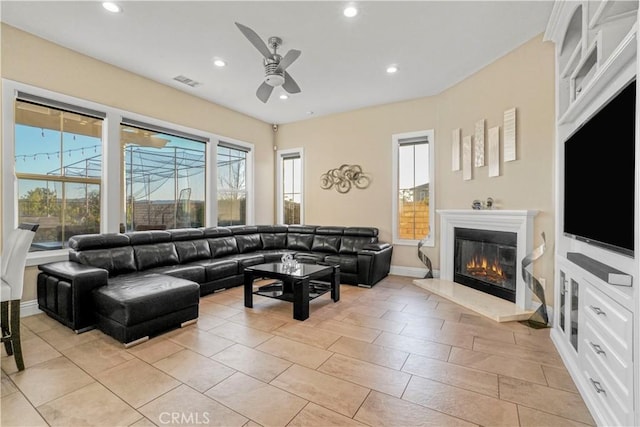 tiled living room featuring ceiling fan