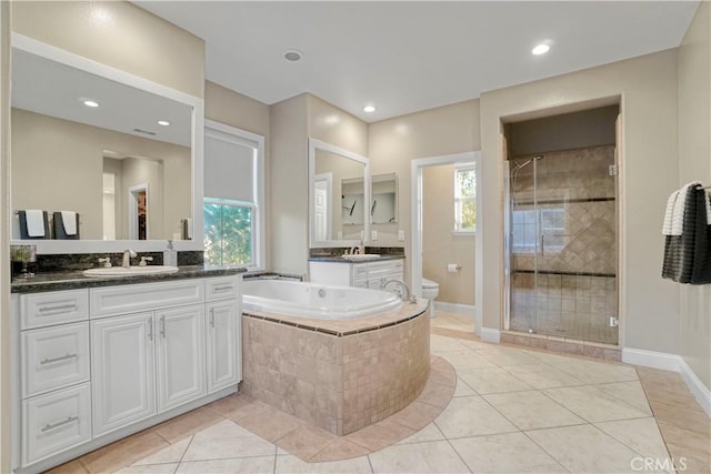 full bathroom featuring tile patterned floors, vanity, independent shower and bath, and toilet