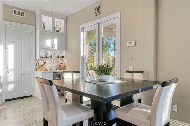 dining space with wine cooler and indoor bar