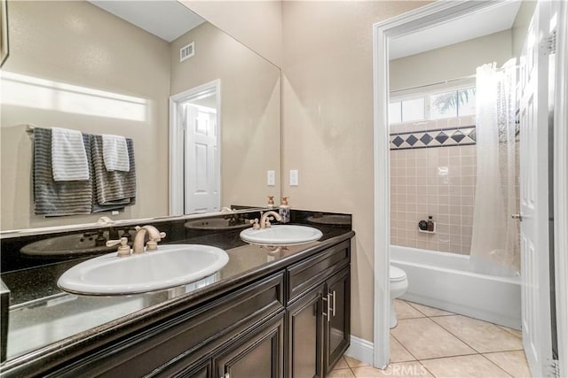 full bathroom featuring tile patterned flooring, shower / bath combo, vanity, and toilet