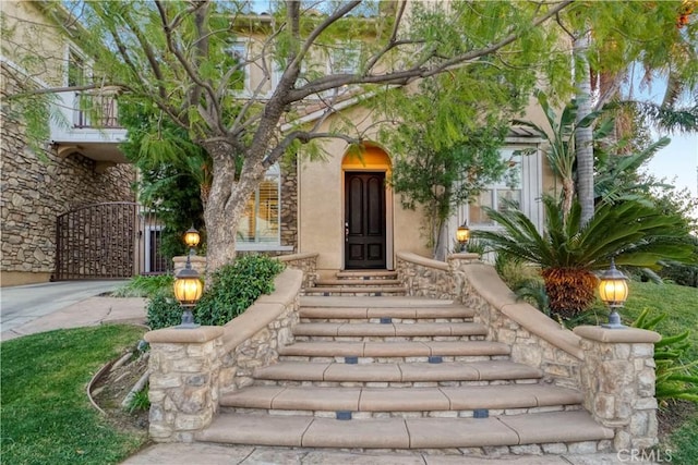 entrance to property featuring stucco siding