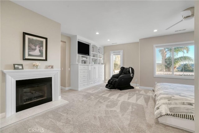 carpeted bedroom with recessed lighting, visible vents, a glass covered fireplace, and baseboards