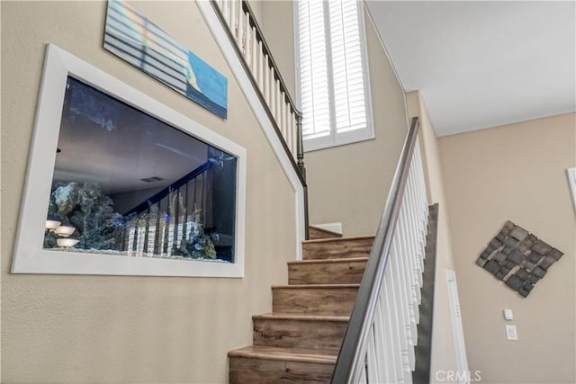 stairs featuring a towering ceiling