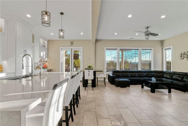 living room featuring ceiling fan and recessed lighting