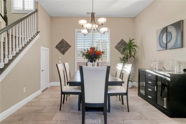 dining area with stairs, a wealth of natural light, a chandelier, and baseboards