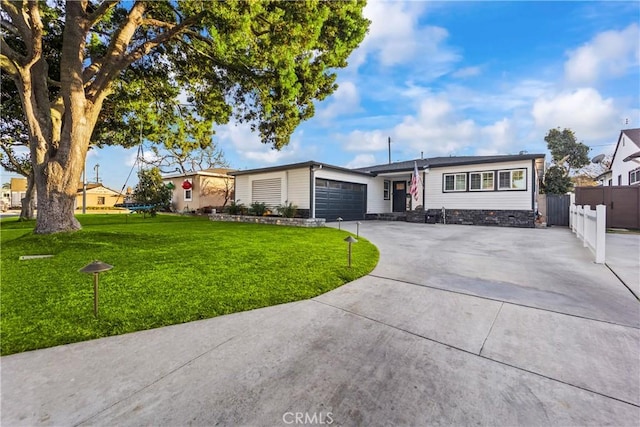 ranch-style house featuring a garage and a front yard