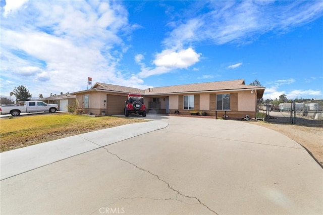 single story home featuring a garage and a front lawn