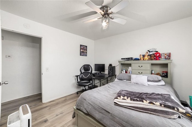 bedroom featuring light hardwood / wood-style floors and ceiling fan