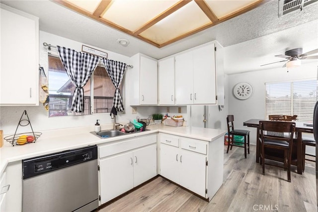 kitchen with sink, light hardwood / wood-style flooring, stainless steel dishwasher, ceiling fan, and white cabinetry