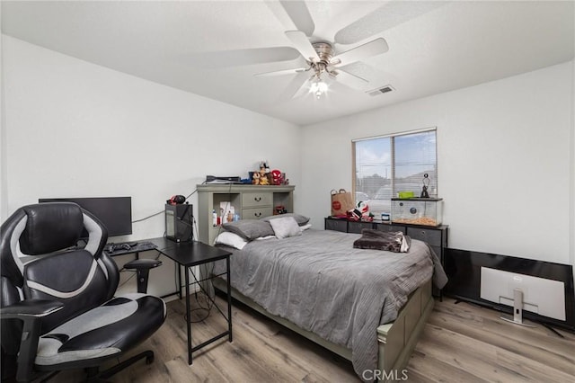 bedroom with ceiling fan and light wood-type flooring