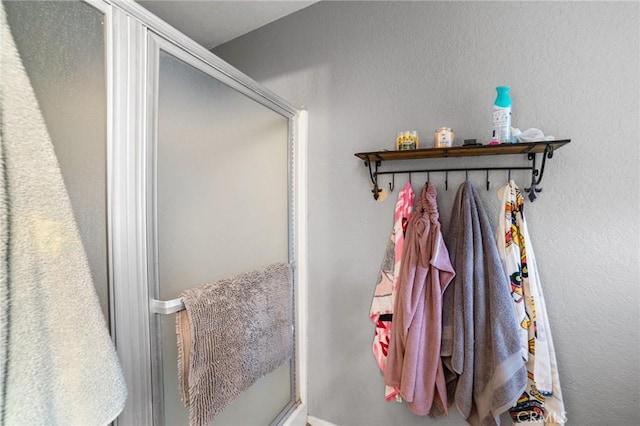 bathroom featuring a shower with door