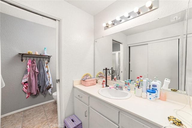 bathroom with tile patterned floors, vanity, and toilet