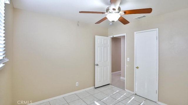 unfurnished bedroom with a closet, ceiling fan, and light tile patterned flooring