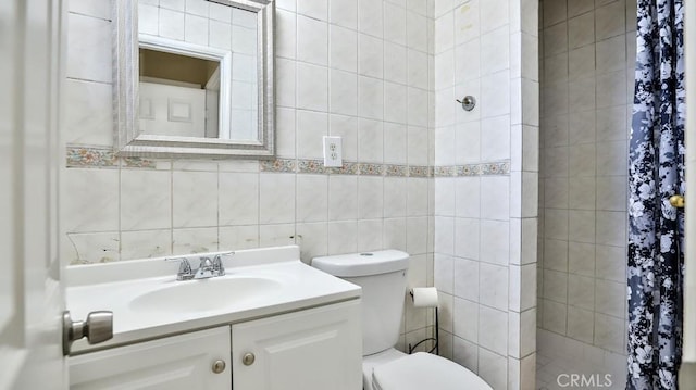 bathroom featuring a shower with curtain, vanity, toilet, and tile walls