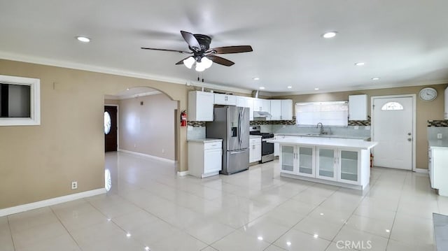 kitchen featuring white cabinets, appliances with stainless steel finishes, a center island, and sink