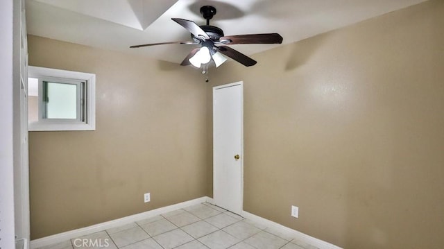 spare room featuring ceiling fan and light tile patterned floors