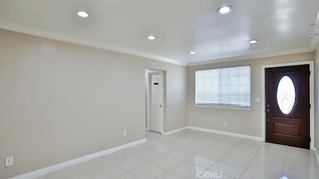 tiled foyer entrance with crown molding