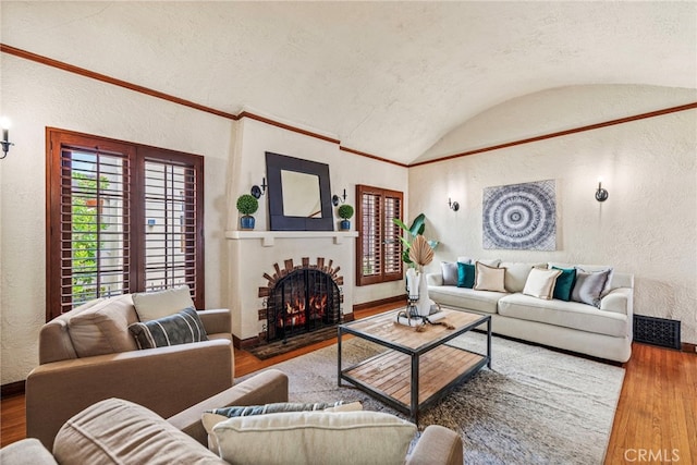 living room featuring hardwood / wood-style floors, lofted ceiling, and brick ceiling