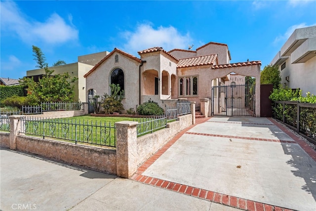 mediterranean / spanish house with a front lawn