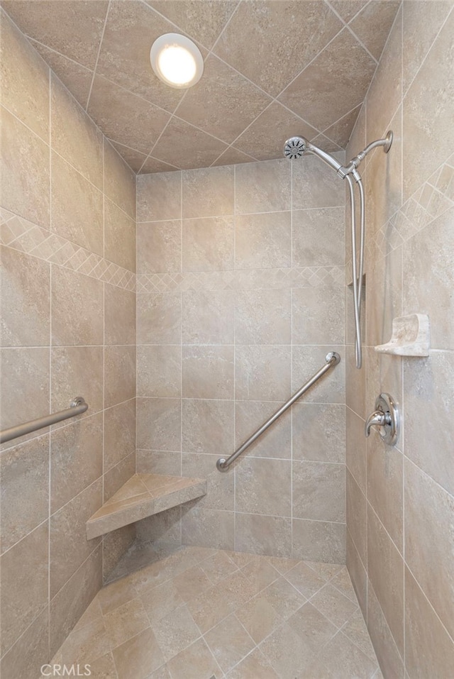 bathroom with tiled shower