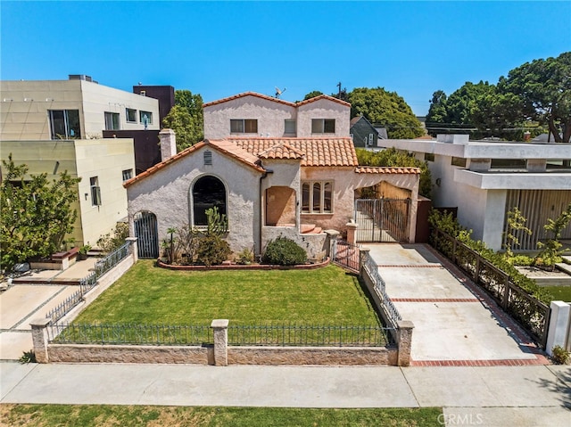 mediterranean / spanish-style home with a front lawn