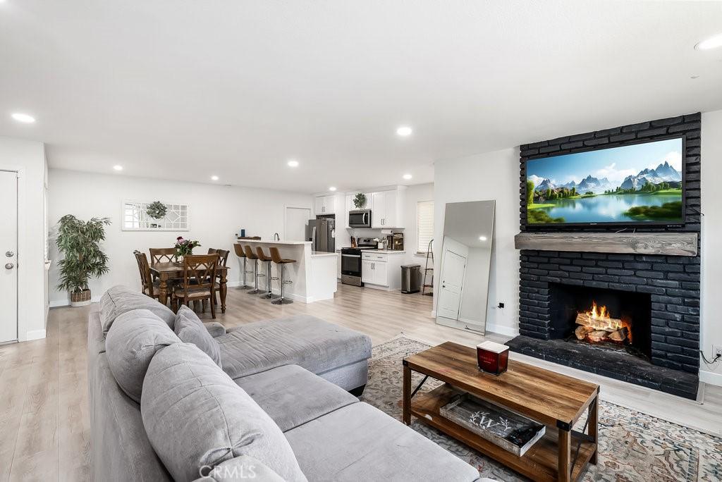 living room with a fireplace and light hardwood / wood-style flooring