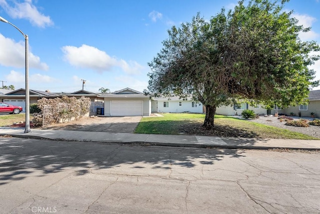 view of front of property featuring a garage and a front lawn