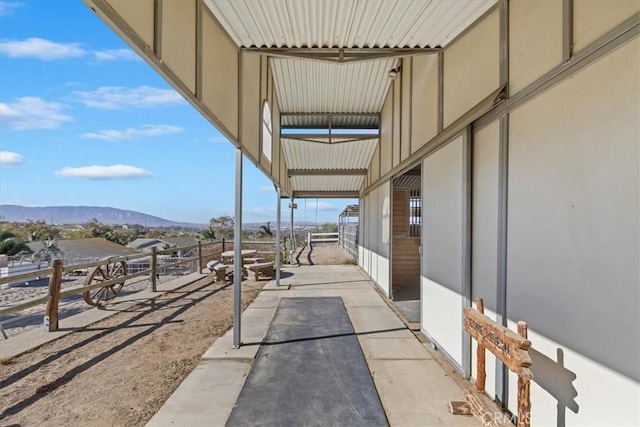 view of patio / terrace with a mountain view and an outbuilding