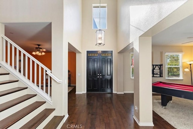 foyer entrance with ceiling fan, dark wood-type flooring, and pool table