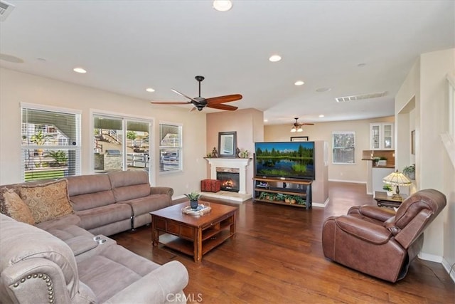 living room featuring dark hardwood / wood-style flooring and ceiling fan