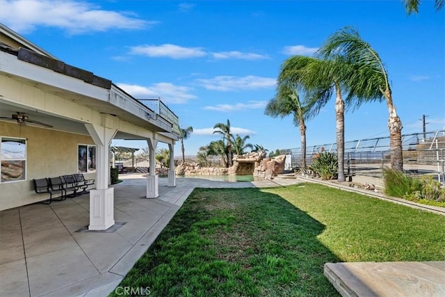 view of yard with a patio and ceiling fan